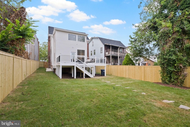 back of house with a yard and a wooden deck