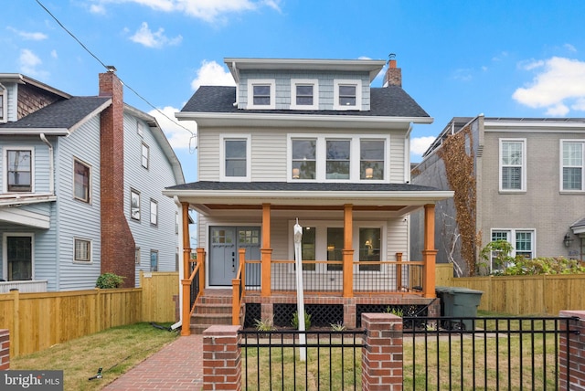 view of front facade featuring covered porch and a front lawn