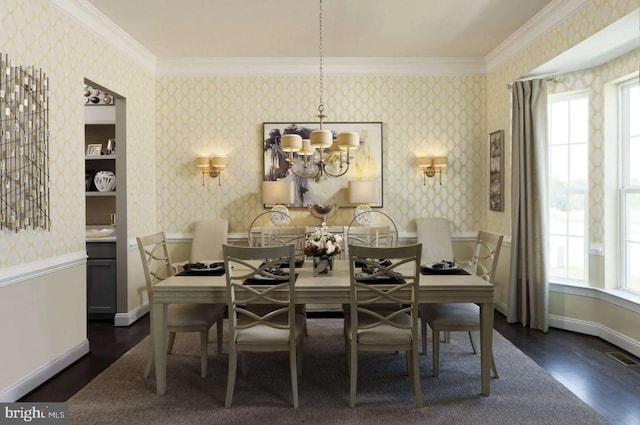 dining area featuring dark hardwood / wood-style floors, an inviting chandelier, and ornamental molding