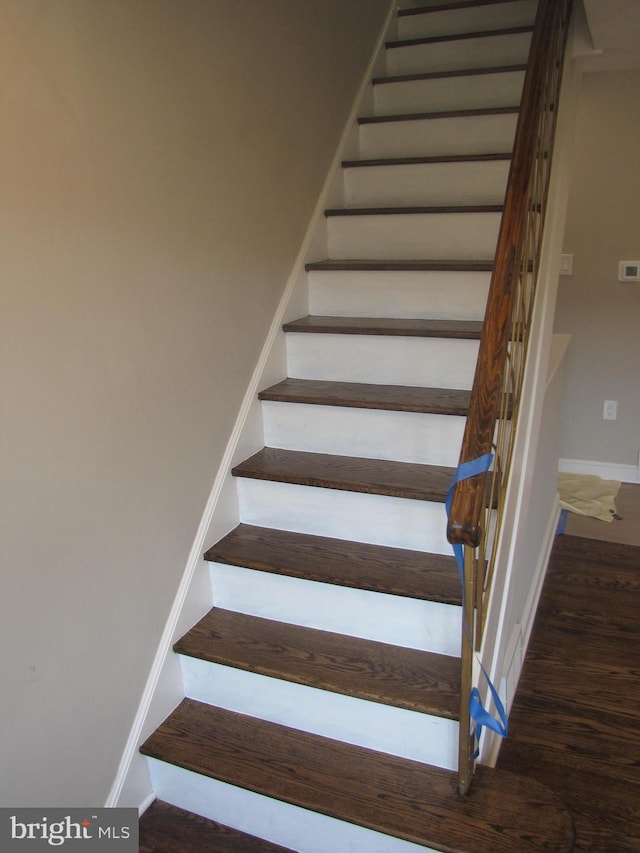 stairs featuring hardwood / wood-style flooring