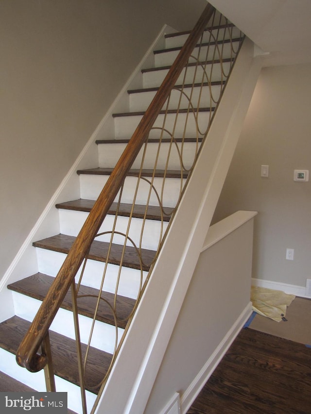 staircase with wood-type flooring