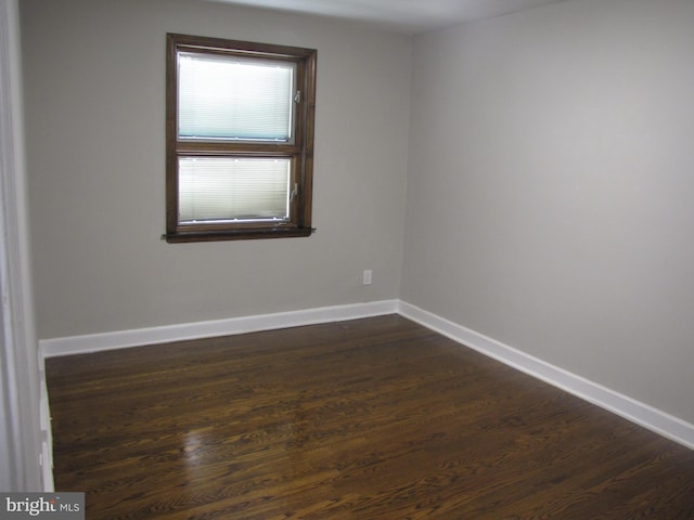 empty room featuring dark wood-type flooring