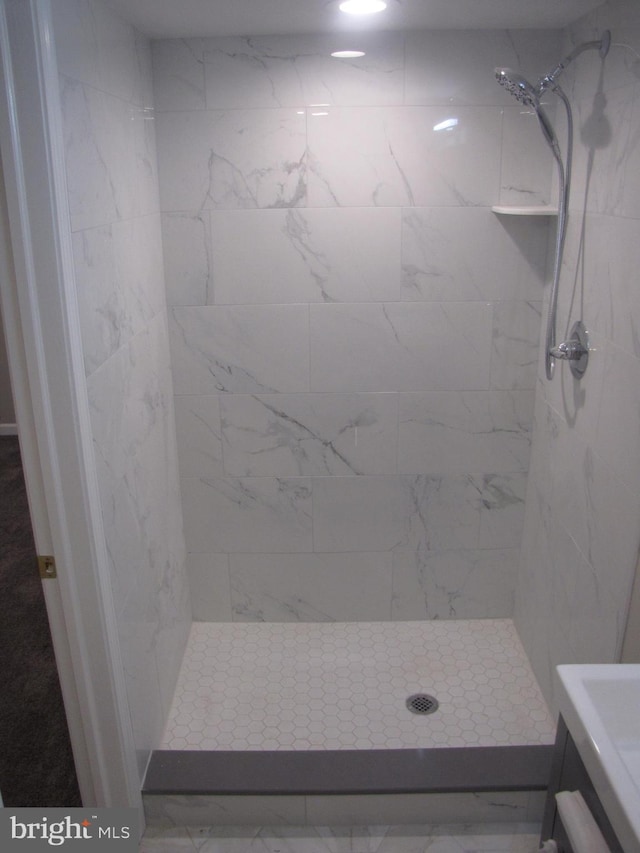 bathroom with a tile shower