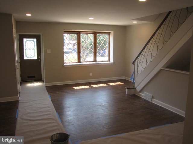 entryway with dark hardwood / wood-style flooring