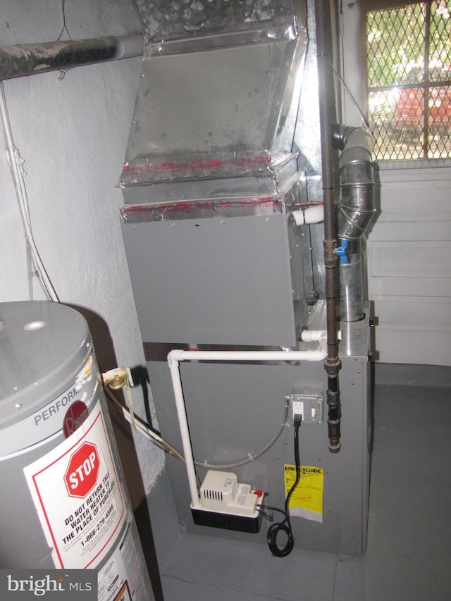 utility room with heating unit and water heater