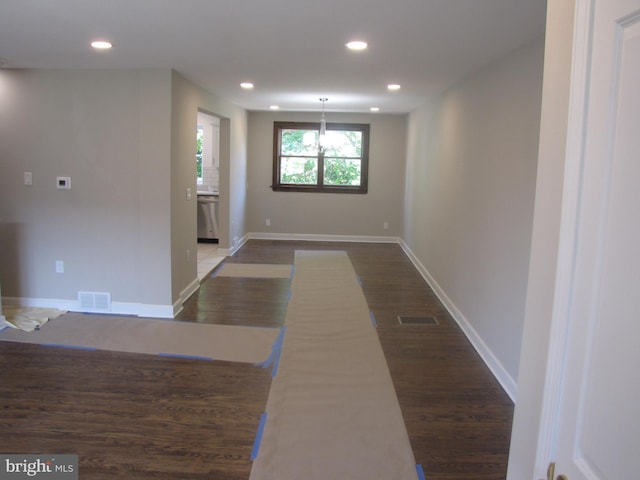 hallway featuring dark hardwood / wood-style flooring