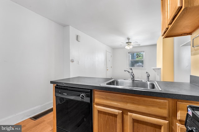 kitchen with ceiling fan, washer / clothes dryer, sink, black dishwasher, and light wood-type flooring