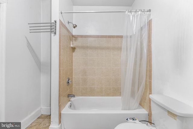 bathroom featuring toilet, tile patterned floors, and shower / bath combo with shower curtain