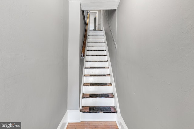 stairs with hardwood / wood-style floors