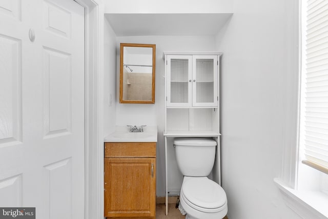 bathroom featuring toilet and vanity