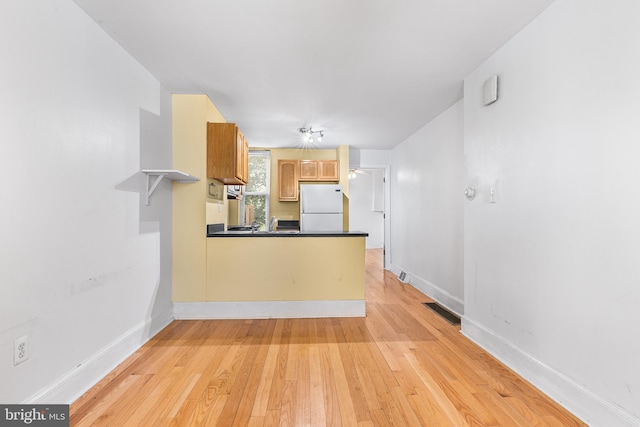 unfurnished living room with light hardwood / wood-style flooring