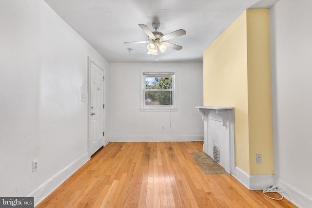 unfurnished living room featuring ceiling fan and light wood-type flooring