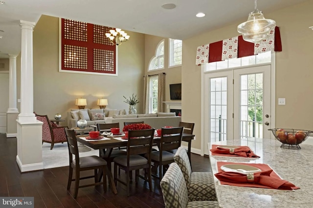 dining space featuring dark wood-type flooring and a notable chandelier