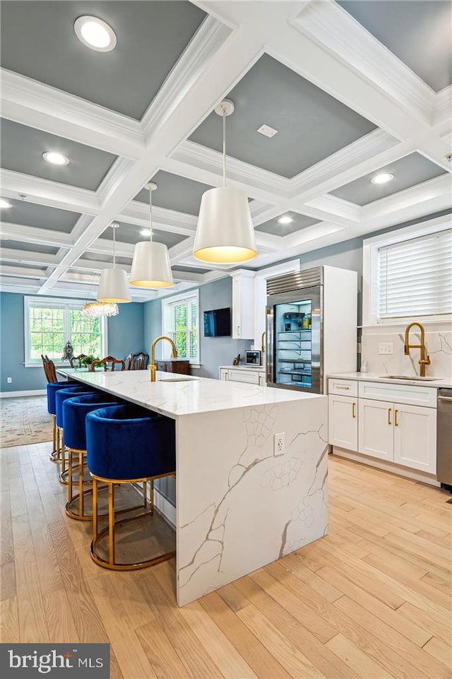 kitchen with decorative light fixtures, sink, appliances with stainless steel finishes, and a large island