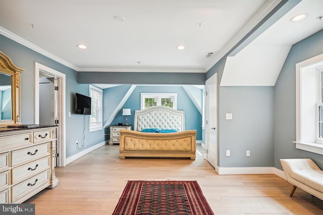 bedroom featuring light hardwood / wood-style flooring, ornamental molding, and vaulted ceiling