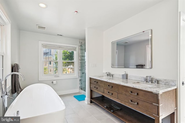 bathroom featuring separate shower and tub, vanity, and tile patterned flooring