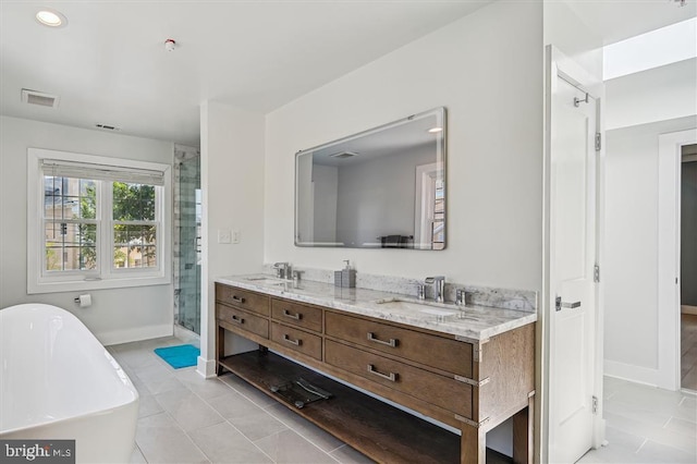 bathroom with plus walk in shower, tile patterned flooring, and vanity