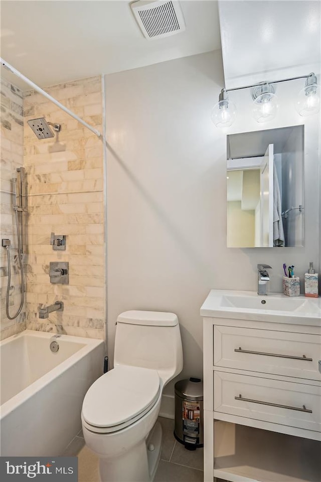 full bathroom with toilet, tile patterned floors, tiled shower / bath, and vanity