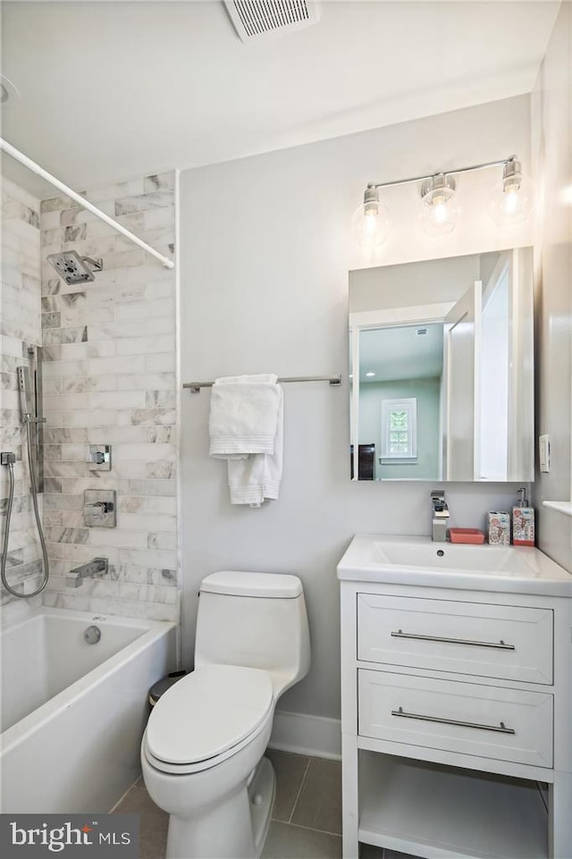 full bathroom featuring toilet, tiled shower / bath combo, tile patterned floors, and vanity