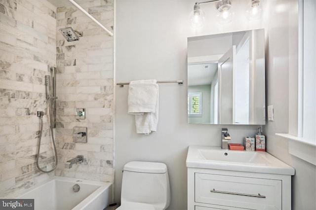 full bathroom with toilet, vanity, and tiled shower / bath combo