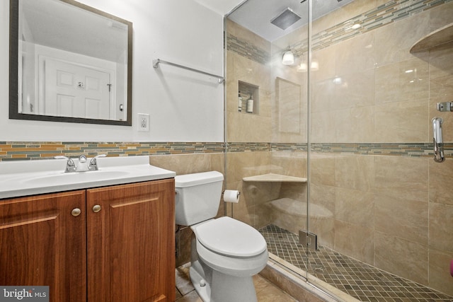 bathroom with tasteful backsplash, vanity, an enclosed shower, and toilet