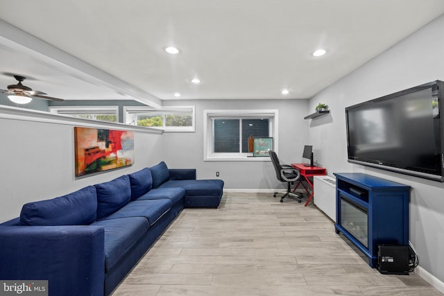 living room with beamed ceiling, ceiling fan, and light hardwood / wood-style flooring