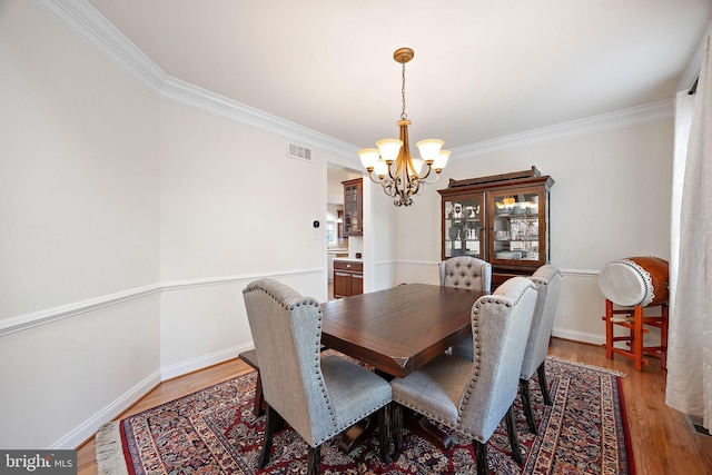 345 Austin Dr, Oxford, PA 19363 - dining room with a chandelier, light wood-style flooring, baseboards, and crown molding