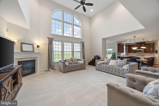 345 Austin Dr, Oxford, PA 19363 - living room featuring a healthy amount of sunlight, a fireplace, light colored carpet, and ceiling fan