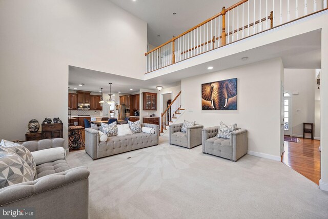 345 Austin Dr, Oxford, PA 19363 - living area with baseboards, stairway, recessed lighting, a towering ceiling, and light colored carpet
