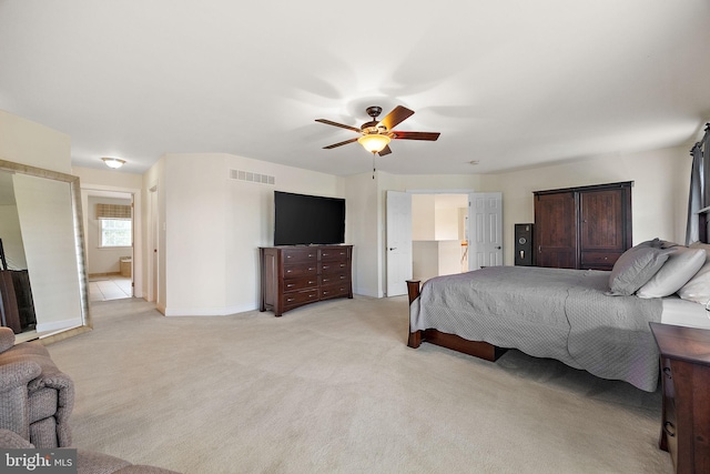 345 Austin Dr, Oxford, PA 19363 - bedroom featuring baseboards, ensuite bathroom, visible vents, ceiling fan, and light colored carpet