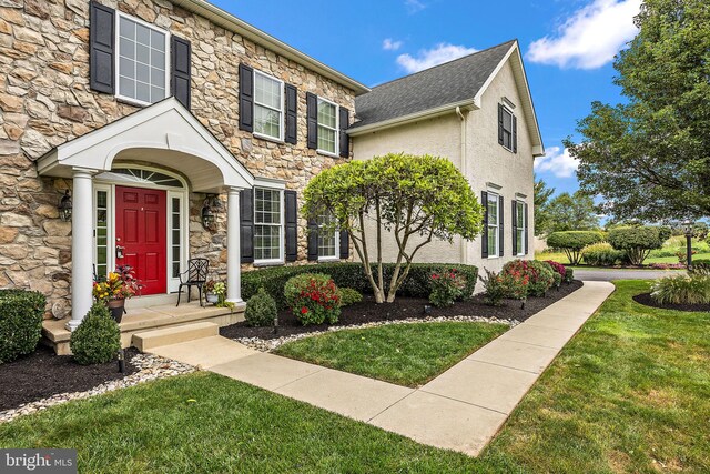 345 Austin Dr, Oxford, PA 19363 - view of front of home with stucco siding, stone siding, and a front lawn