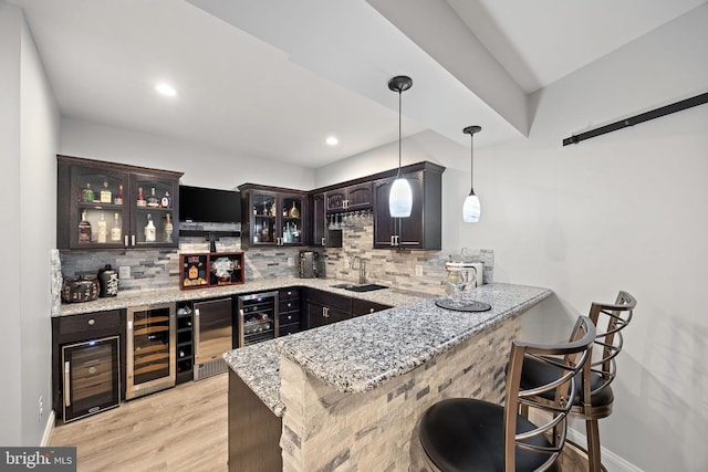 345 Austin Dr, Oxford, PA 19363 - bar with wine cooler, decorative backsplash, light wood-type flooring, and indoor wet bar