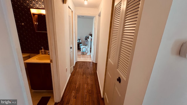 hall featuring dark hardwood / wood-style floors and sink