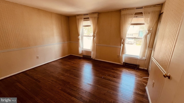 unfurnished room with dark wood-type flooring