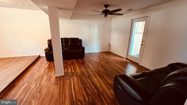 sitting room with wood-type flooring and ceiling fan