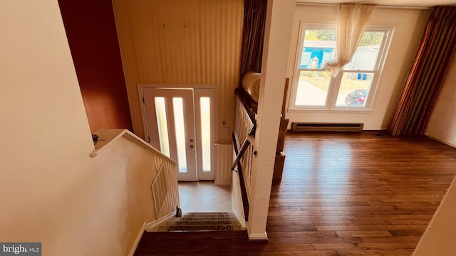 doorway featuring dark hardwood / wood-style floors and a baseboard heating unit