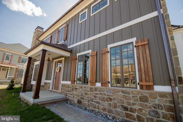 view of exterior entry with a porch