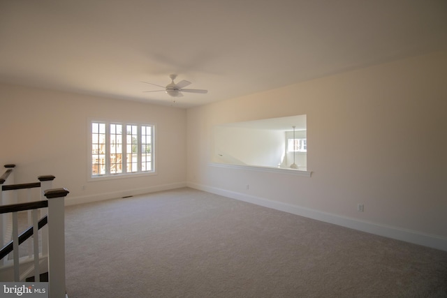 unfurnished room featuring light colored carpet and ceiling fan