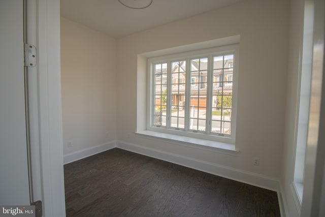 empty room with dark wood-type flooring