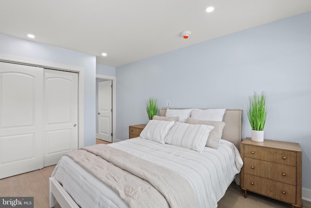 bedroom featuring light hardwood / wood-style flooring and a closet