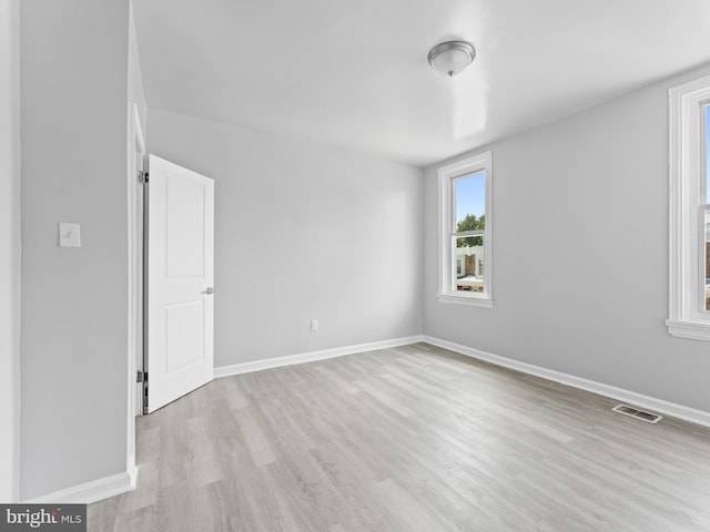 spare room featuring light hardwood / wood-style flooring