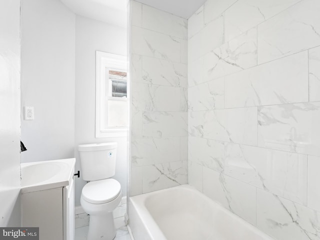 full bathroom with toilet, vanity, and tiled shower / bath