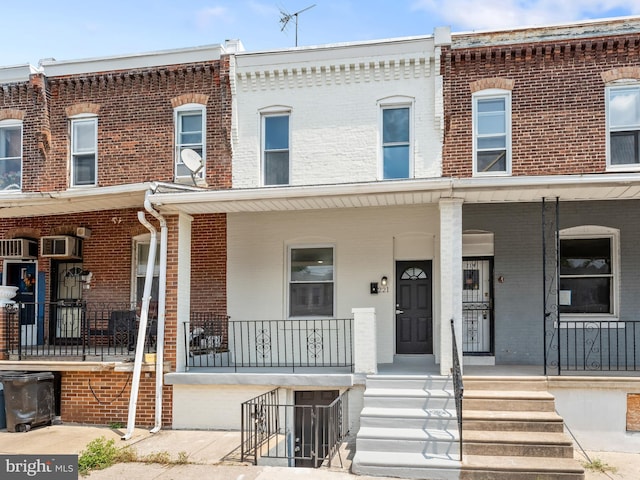 townhome / multi-family property with a porch