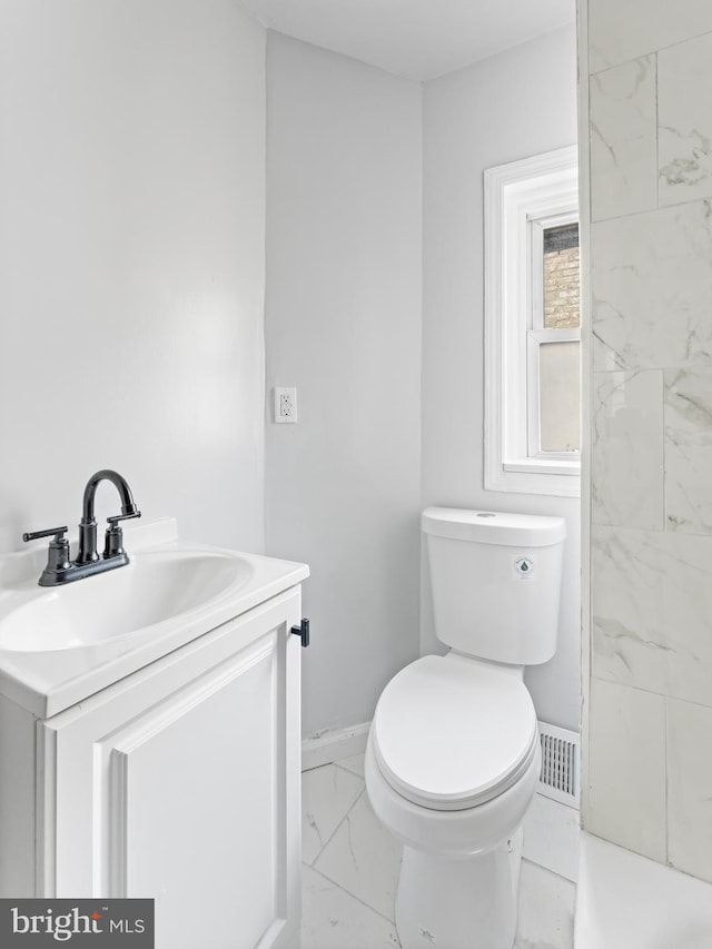 bathroom featuring toilet and vanity