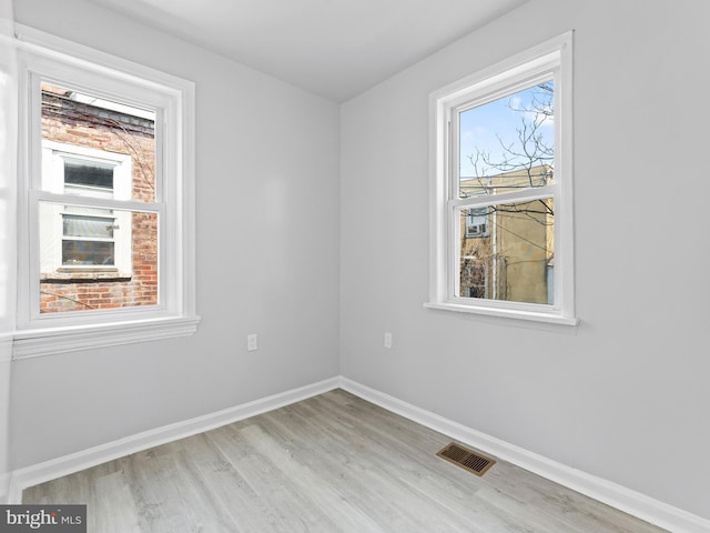 spare room with light hardwood / wood-style floors