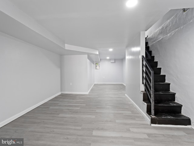 basement with light hardwood / wood-style floors