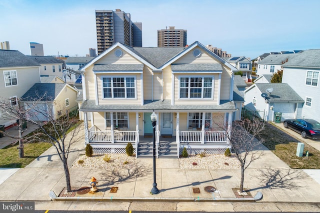 view of front of home featuring a porch and a garage