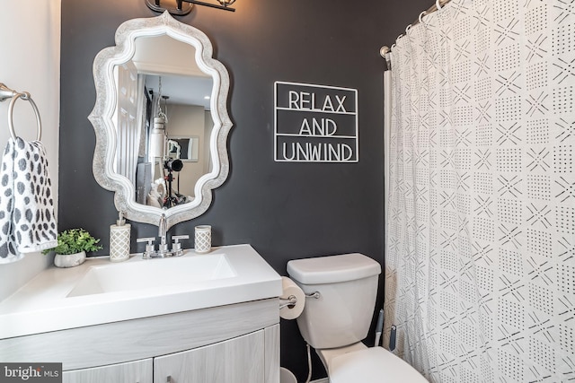 bathroom featuring toilet and vanity