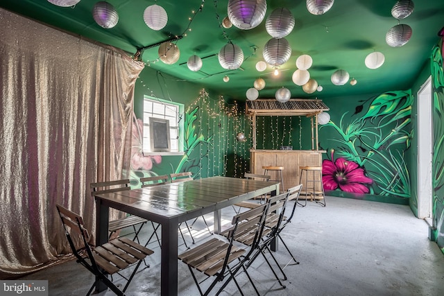 unfurnished dining area featuring concrete flooring