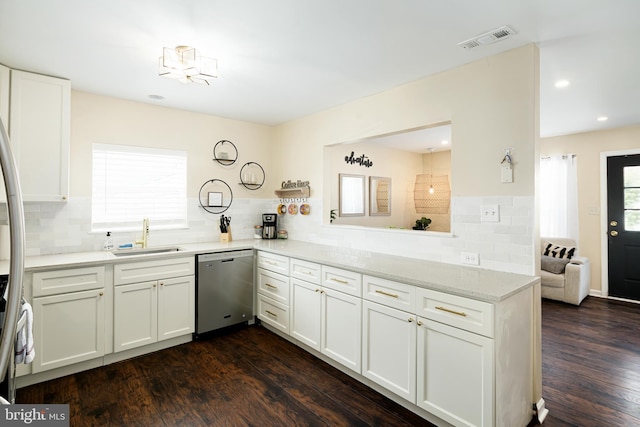 kitchen featuring sink, stainless steel dishwasher, backsplash, and dark wood-type flooring